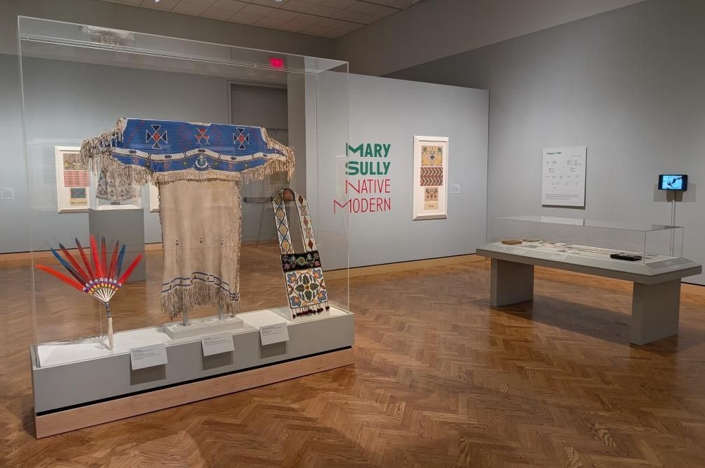 The exhibit, open until Sept. 21, displays Sully's artwork alongside historical Indigenous tribe regalia to highlight how her Dakota culture influenced her work.